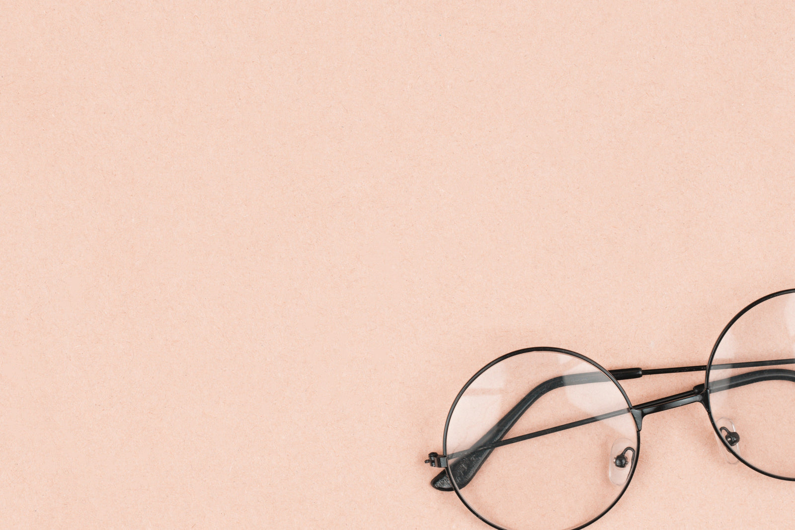 A pair of glasses with a pink background